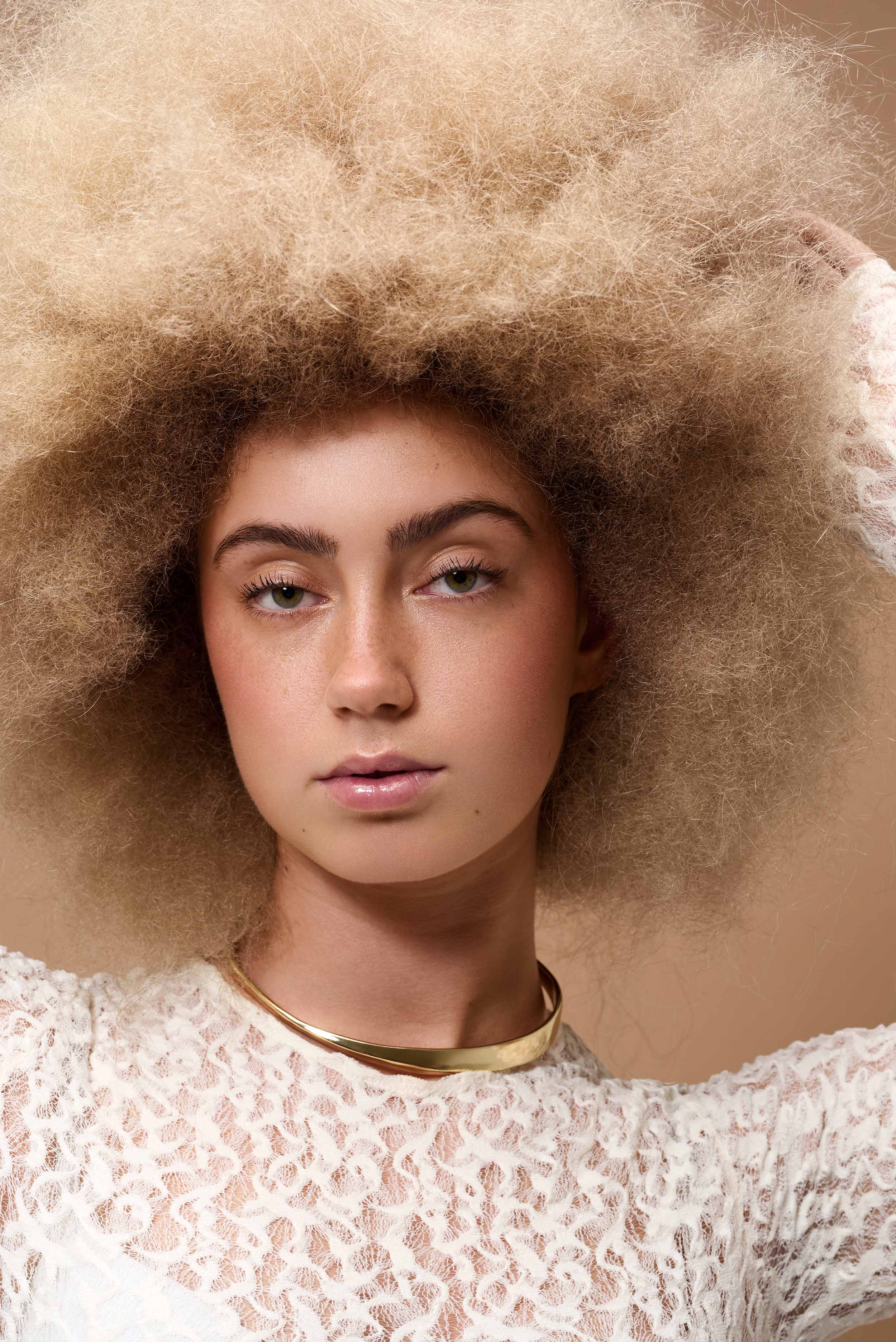 Hair photography for Reggy - large afro hairstyling with white top, contemporary styling and artistic presentation